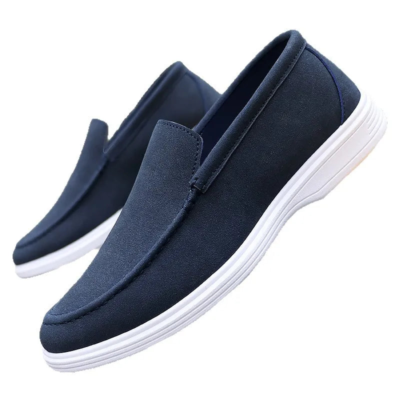 Navy blue suede slip-on loafers for men with white rubber sole, shown as a pair on white background