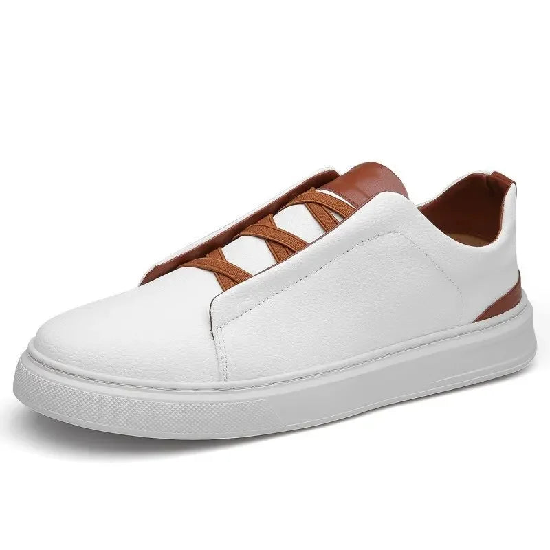 White leather slip-on sneakers with brown elastic laces, contrast trim, and thick white sole for men.