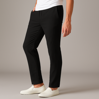 Black drawstring linen pants for men with relaxed fit, worn with white slip-on sneakers