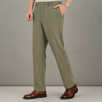 Men's olive green linen drawstring pants with straight leg fit, side pockets, worn with brown leather dress shoes.
