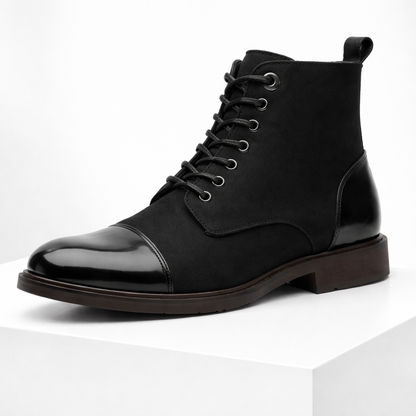 Black men's lace-up ankle boots with shiny leather cap toe, fabric upper, silver eyelets, and dark brown sole.