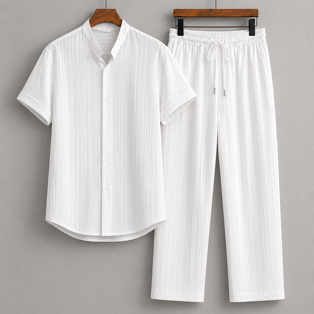 White men's linen two-piece set featuring short-sleeve button-up shirt with stand collar and matching drawstring pants.