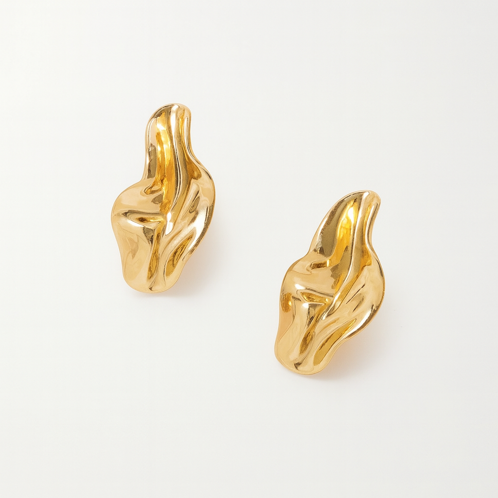 Gold chunky twisted drop earrings with abstract sculptural design and high-polish finish, shown as a pair on white background