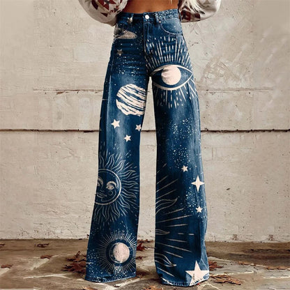 Women's high-waist wide-leg jeans featuring celestial sun, moon, stars, and planet prints on dark blue denim fabric.