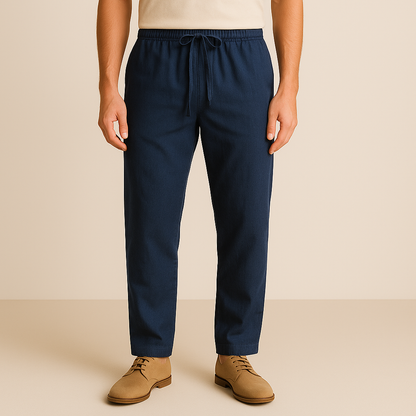 Navy blue linen-cotton drawstring pants for men with elastic waistband and relaxed fit on beige background