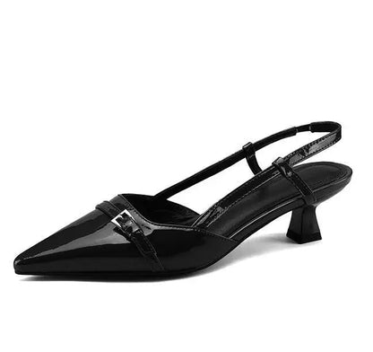 Black patent leather pointed-toe slingback pumps with buckle strap detail and low block kitten heel