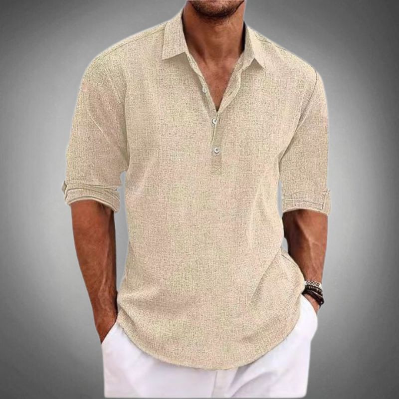 Men's beige linen Henley short sleeve shirt with collar, partial button placket, and rolled sleeves, paired with white pants.
