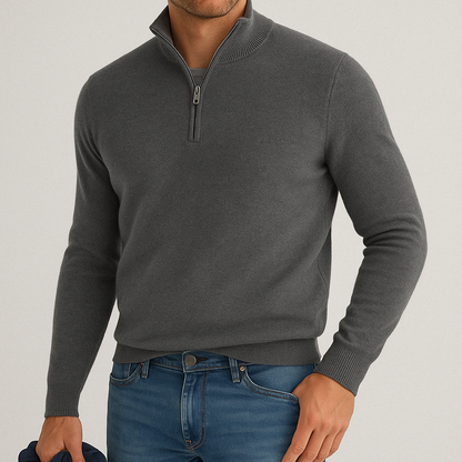 Men's grey cashmere blend quarter-zip sweater with ribbed collar and cuffs, paired with blue jeans.