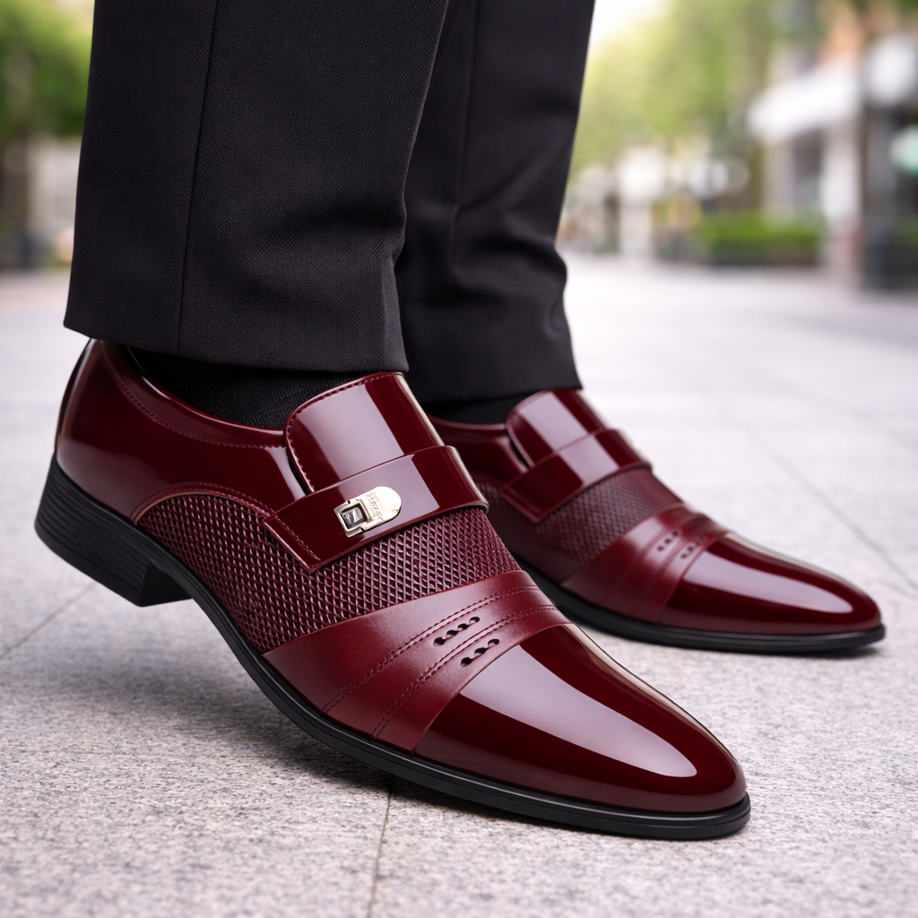 Torreno men's burgundy patent leather slip-on loafers with gold buckle detail and textured strap, worn with black trousers.