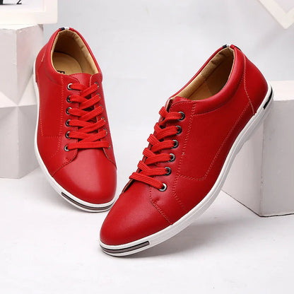 Red leather low-top lace-up sneakers for men with white sole, metal eyelets, and tan interior lining