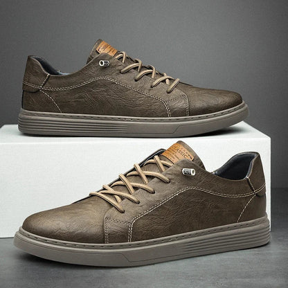 Men's olive brown leather low-top lace-up sneakers with contrast stitching and tan leather tongue label