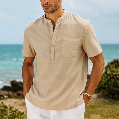 Men's beige linen band collar henley shirt with short sleeves and chest pocket on beach background