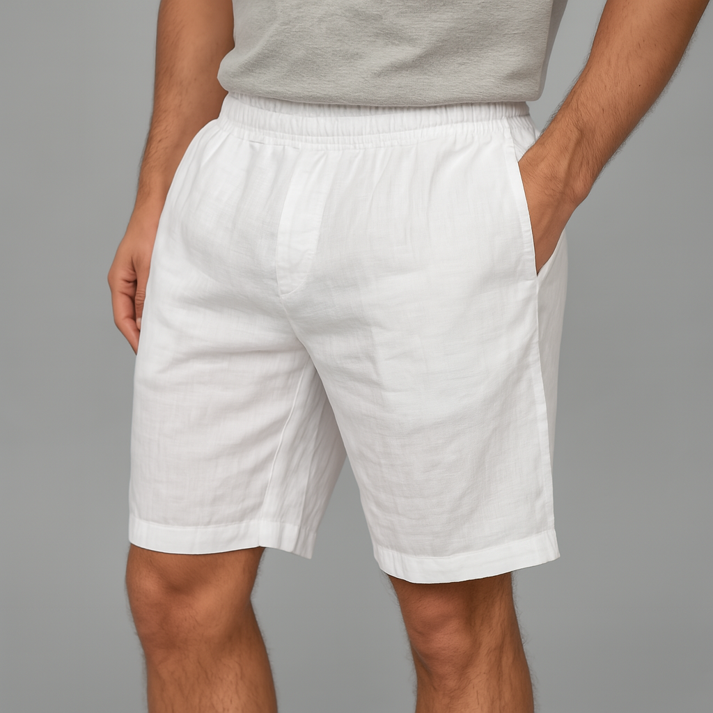 Man wearing white linen drawstring shorts with elastic waistband and side pockets, paired with a gray t-shirt.