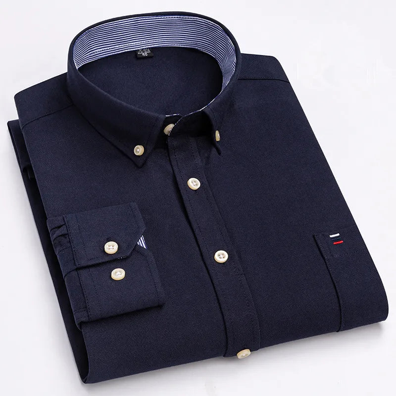 Navy blue men's long-sleeve cotton button-down shirt with striped collar lining, chest pocket, and gold buttons, folded flat.