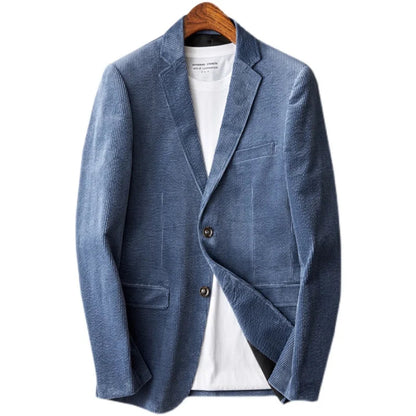 Blue corduroy men's blazer jacket with notch lapels, two buttons, chest pocket, and patch pockets on wooden hanger