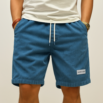 Men's blue corduroy drawstring shorts with rolled cuffs and Alden York label patch, casual summer wear