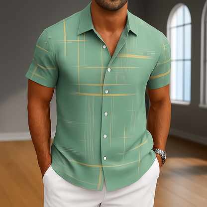 Men's sage green short sleeve button-up shirt with gold plaid stripes, paired with white pants, silver watch.