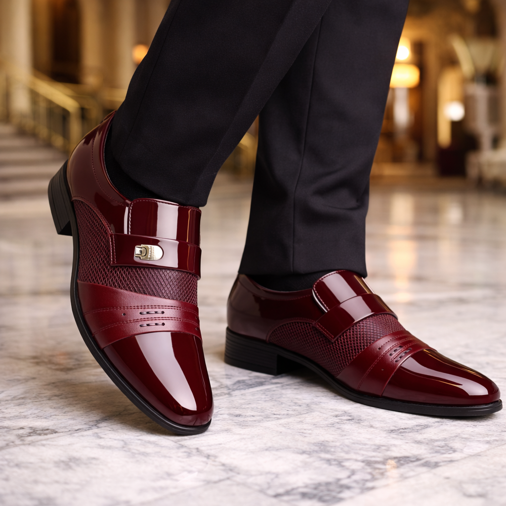 Torreno men's burgundy patent leather slip-on loafers with textured strap and gold buckle detail, worn with black trousers.