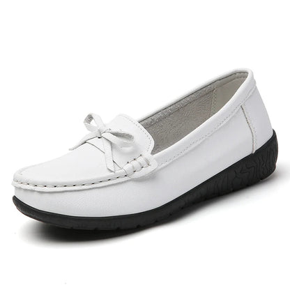 White leather slip-on loafers for women with bow detail and black textured sole