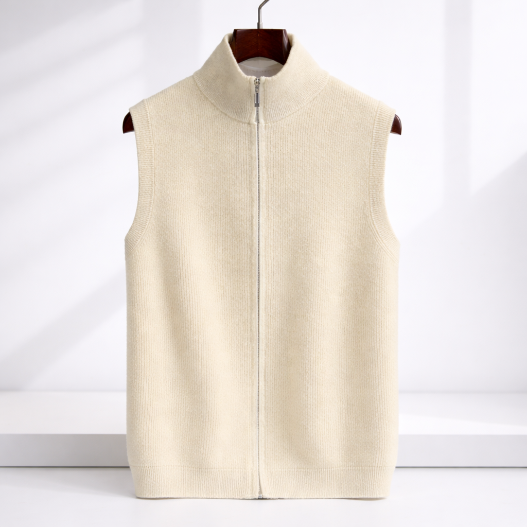 Cream merino wool sleeveless zip-up vest with mock neck collar, displayed on a wooden hanger against white background.