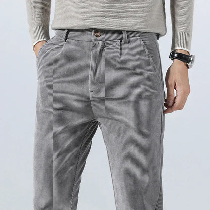 Men's gray corduroy slim fit pants with elastic waist, styled with beige sweater and watch