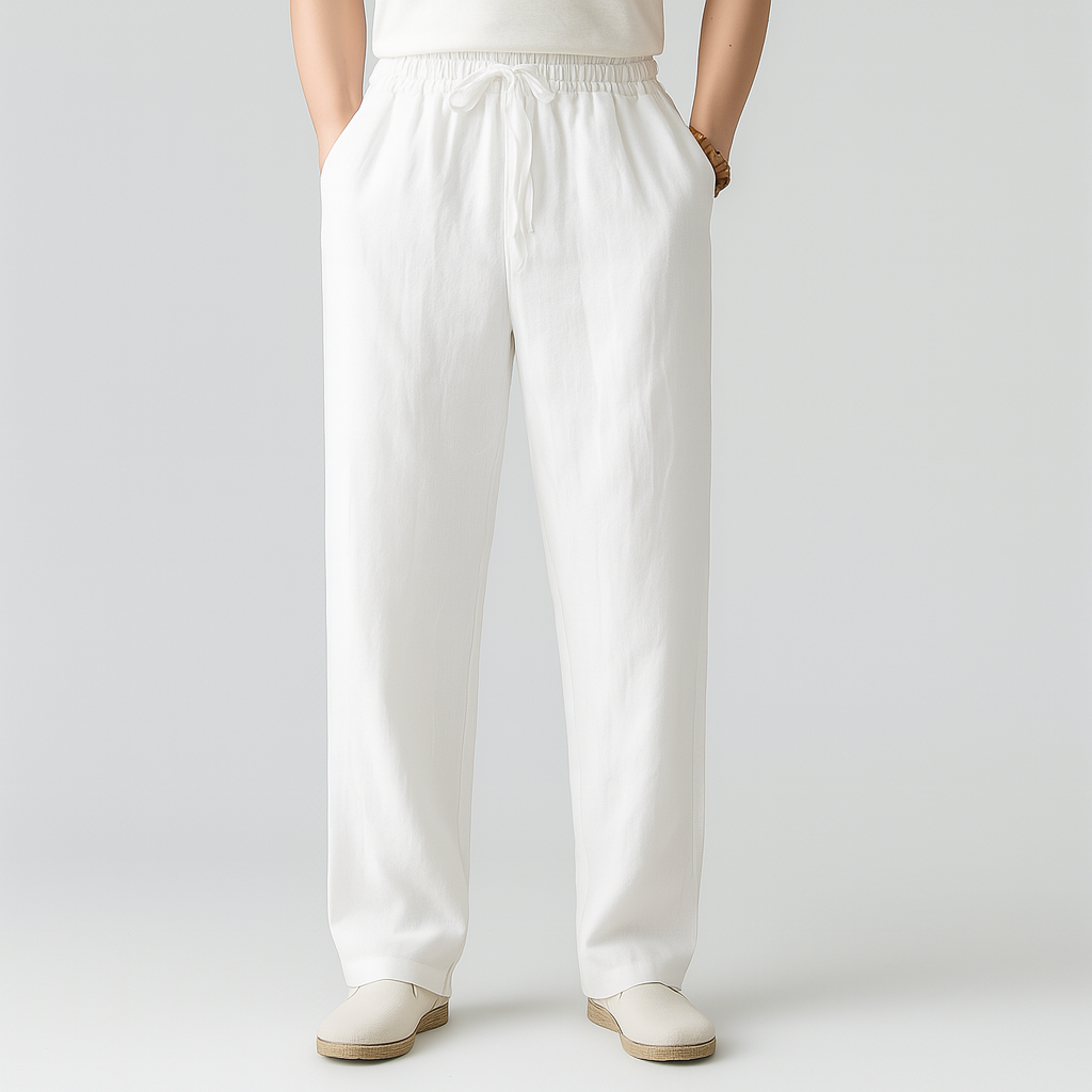 Men's white linen drawstring pants with elastic waistband, relaxed straight fit, side pockets, paired with white slip-on shoes.