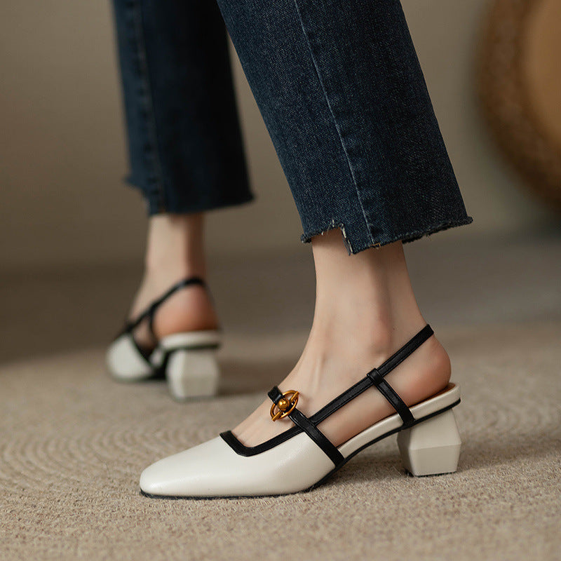 Women's ivory Italian leather block heel slingback sandals with black straps and gold buckle detail, worn with jeans