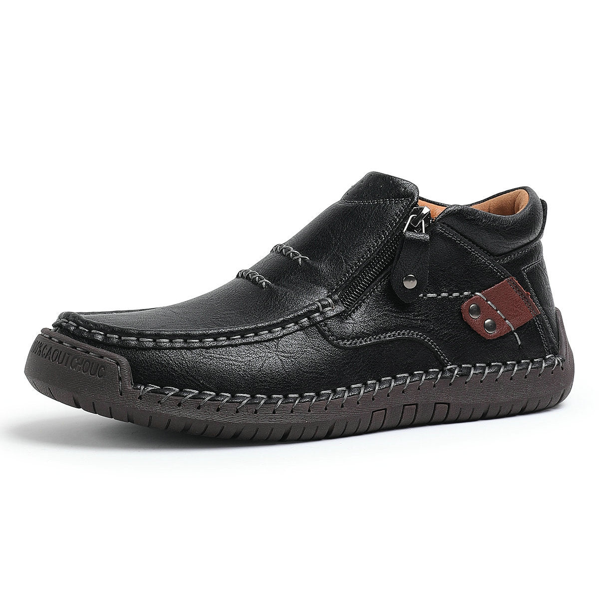 Black men's leather slip-on ankle boot with side zipper, hand-stitching detail, brown accent strap, and rubber sole.
