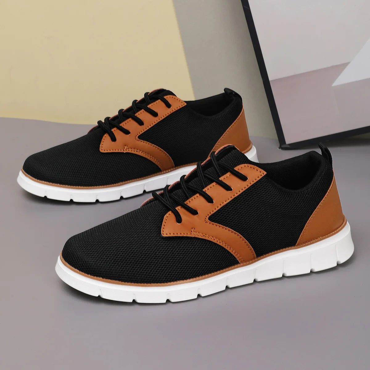 Black canvas sneakers with tan leather accents, lace-up closure, and white orthopedic sole, casual women's style