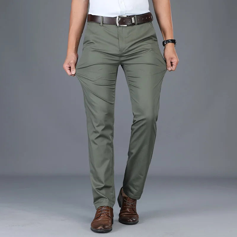 Men's slim fit olive green cotton blend dress pants with brown leather belt and brown dress shoes