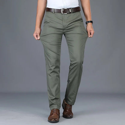Men's slim fit olive green cotton blend dress pants with brown leather belt and brown dress shoes