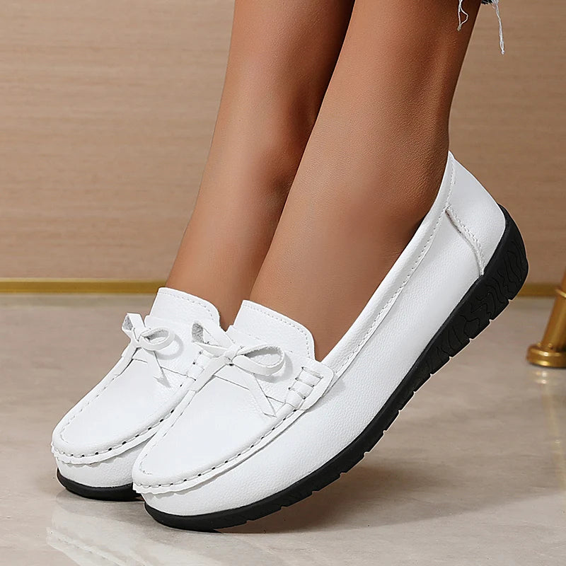 White leather slip-on loafers with bow detail and black sole for women casual comfort shoes